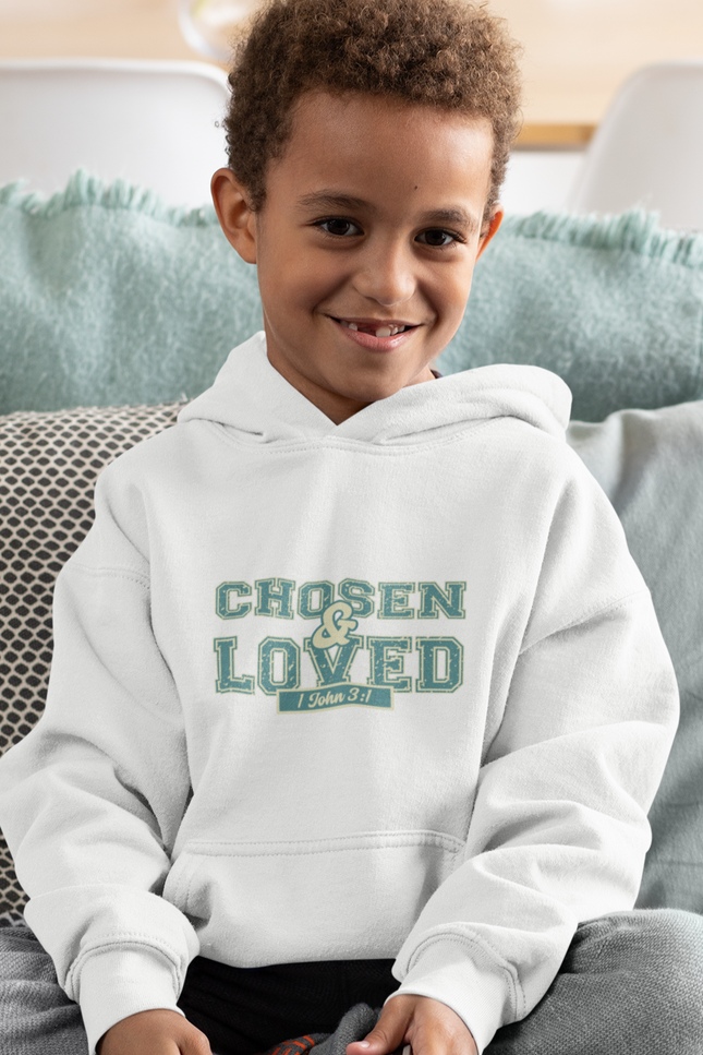 Child wearing a hoodie with 'Chosen & Loved' text, sitting on a couch.