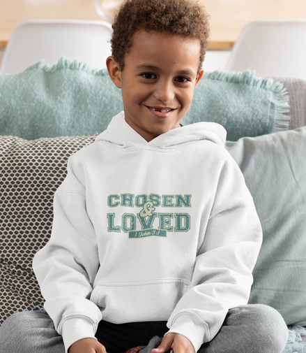 Child wearing a hoodie with 'Chosen & Loved' text, sitting on a couch.