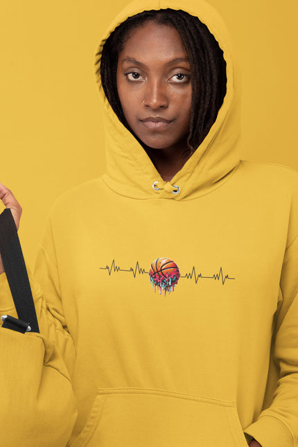 Person wearing a yellow hoodie with a colorful design on a mustard yellow background