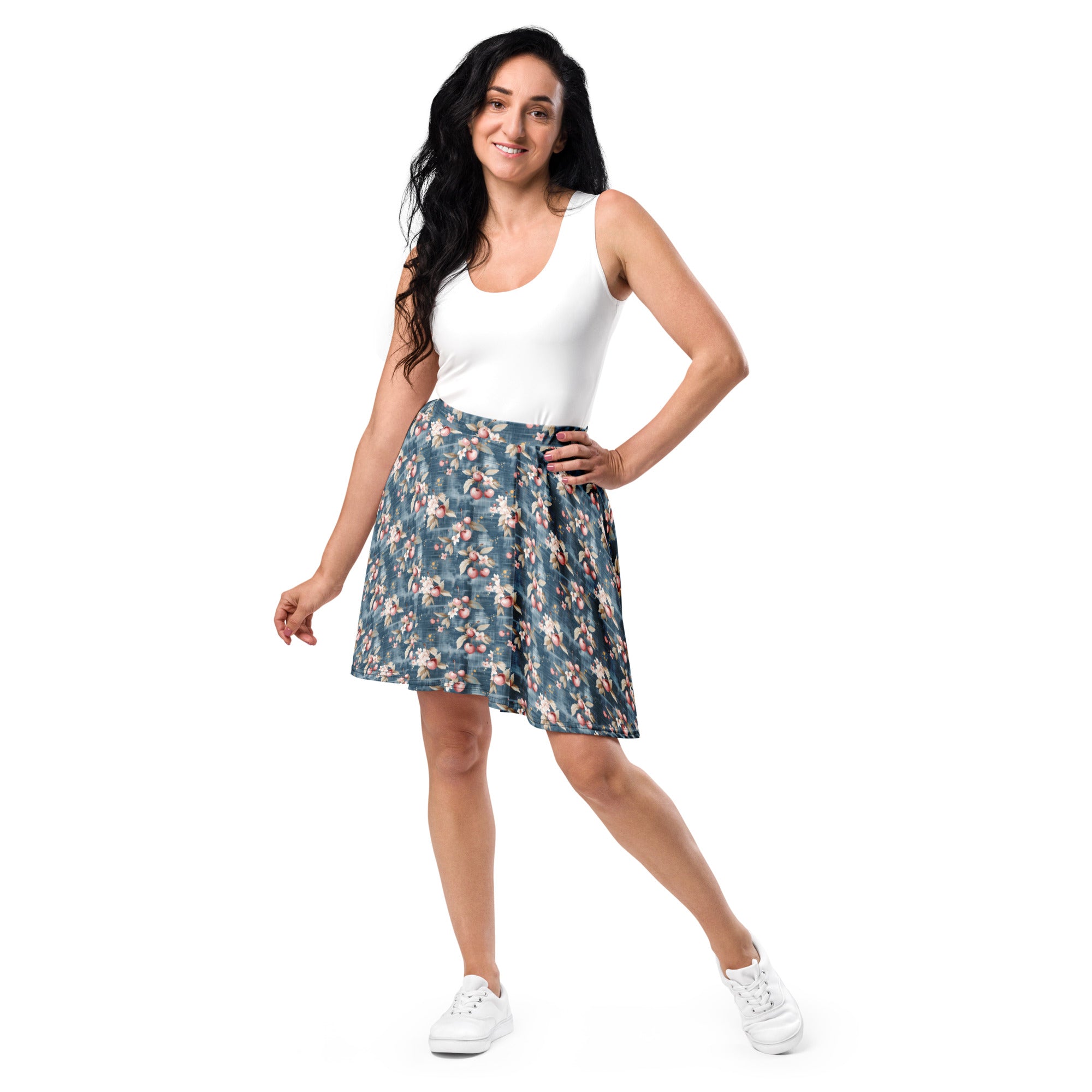 Woman wearing a white tank top and floral skirt on a white background
