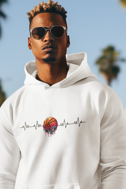 Man wearing a white hoodie with a colorful design in a beach setting