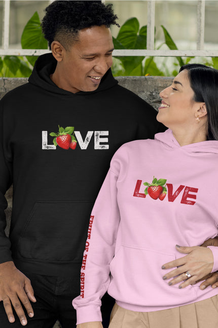Two people wearing black and pink hoodies with 'LOVE' and strawberry graphics.
