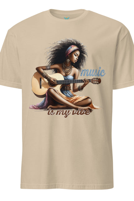 Beige t-shirt with a graphic of a woman playing guitar and 'music is my vibe' text on a white background